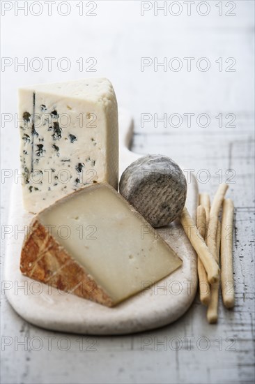 Wedges of cheese and bread sticks