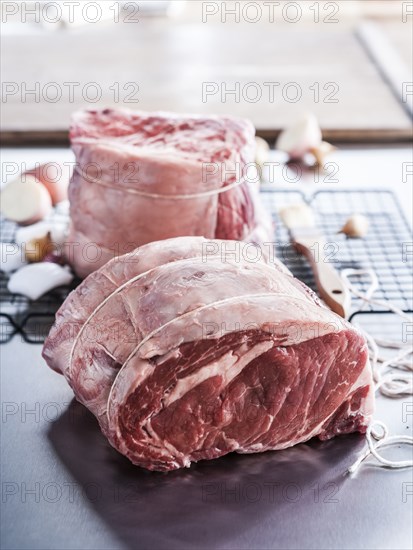 Raw beef rib roast wrapped with string
