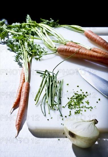 Vegetables and knife on cutting board