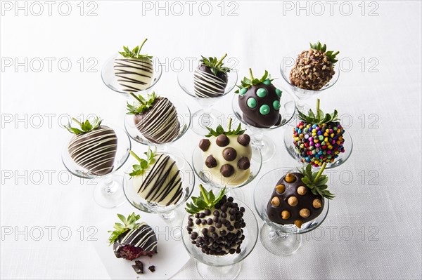 Variety of chocolate-covered strawberries in glasses