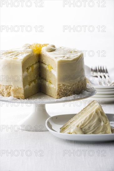 Slice of coconut cream cake on plate