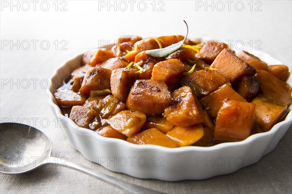 Plate of candied yams and spoon