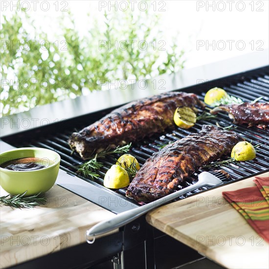 Beef ribs cooking on barbecue grille