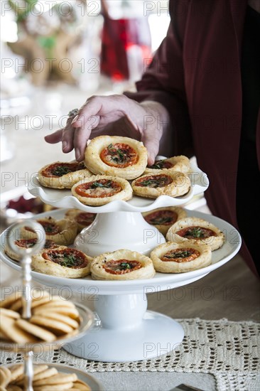 Hand holding holiday tart on tray