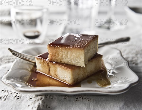 Flan on plate with syrup and fork