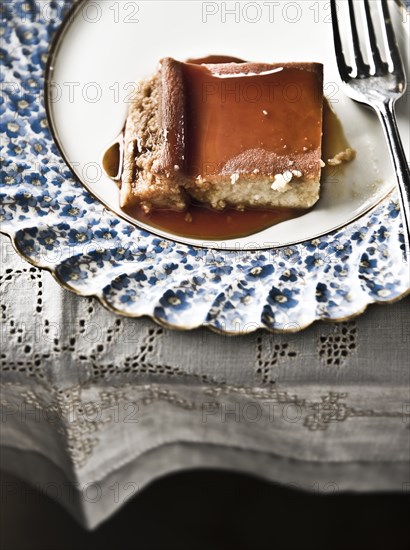 Flan on plate with syrup and fork