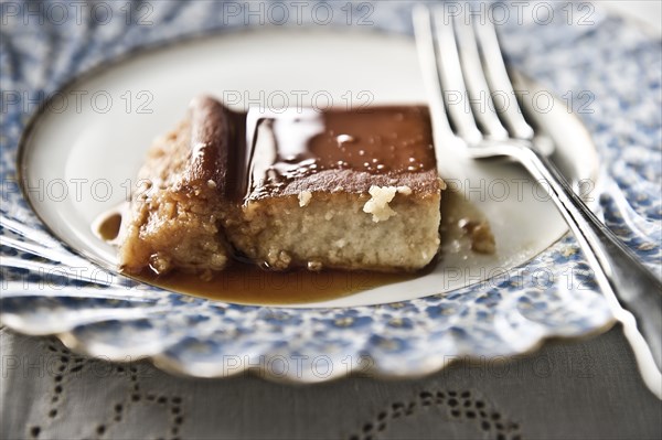 Flan on plate with syrup and fork