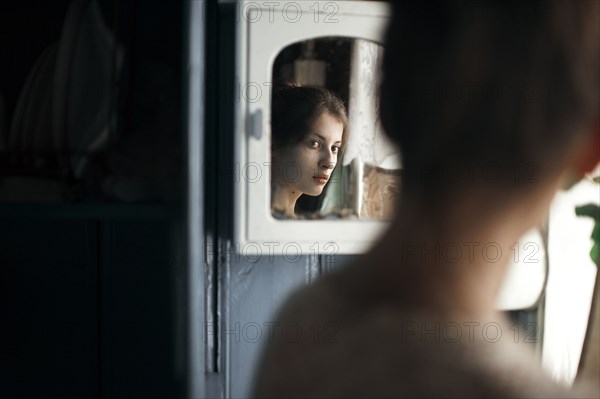 Caucasian woman admiring herself in mirror