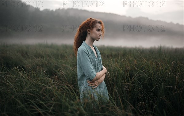 Caucasian woman standing in rural field