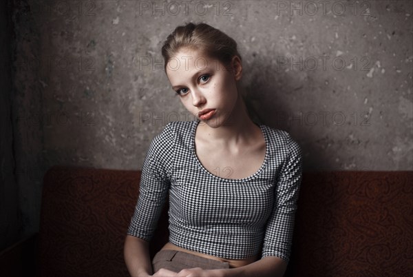 Caucasian woman sitting indoors