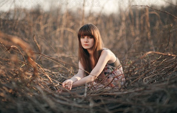 Caucasian woman sitting in field