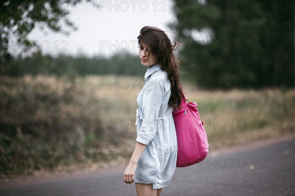 Caucasian woman walking on rural road