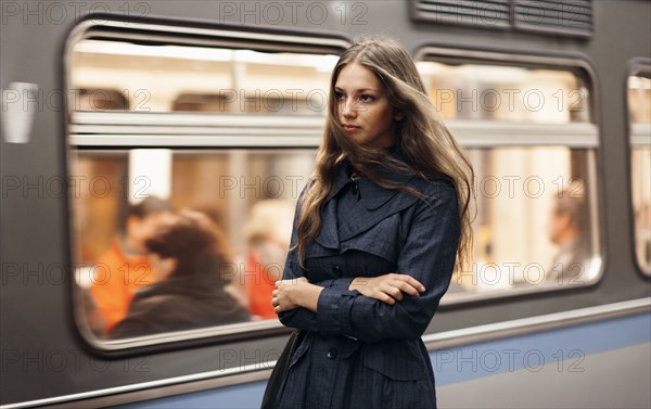 Caucasian woman waiting for subway train
