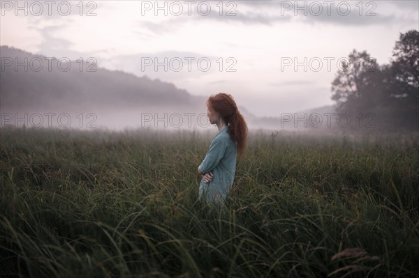 Caucasian woman standing in remote field