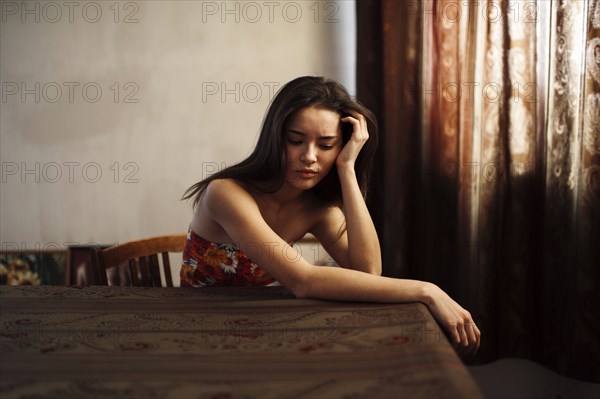 Caucasian woman sitting at table