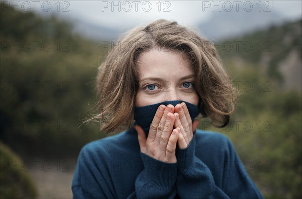 Caucasian woman wearing turtleneck sweater outdoors