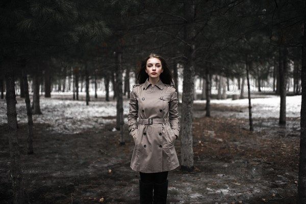 Caucasian woman standing in snowy forest