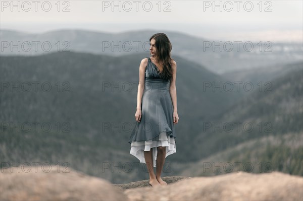 Caucasian woman standing on remote mountaintop