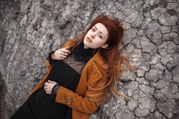 Caucasian woman laying on rock formation