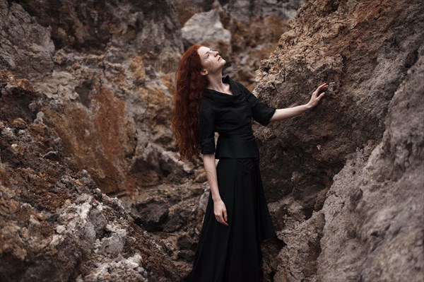 Caucasian woman walking on rocky hillside