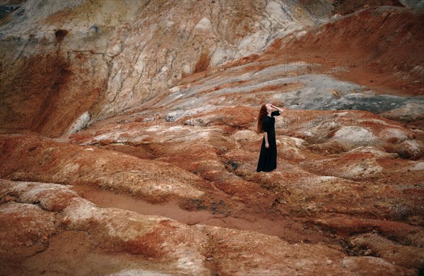 Caucasian woman walking on rock formation