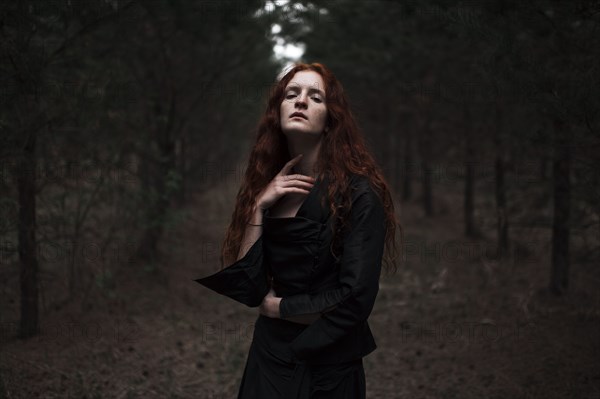 Caucasian woman walking on forest path