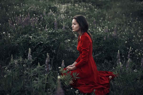 Caucasian woman sitting in field