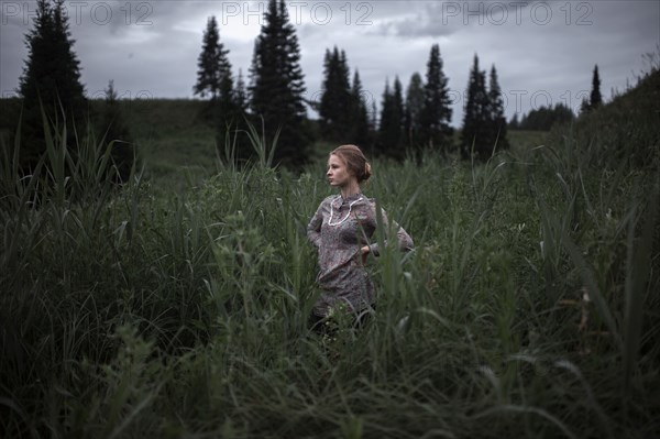 Caucasian woman standing in remote field