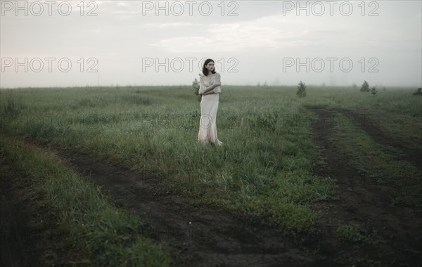 Caucasian woman standing in remote field