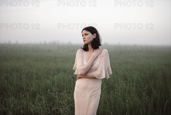 Caucasian woman standing in remote field