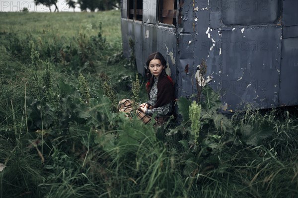 Caucasian woman sitting near remote field