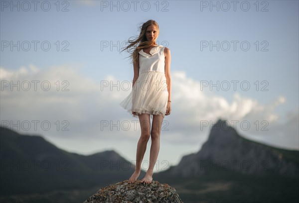 Caucasian woman standing on remote hilltop