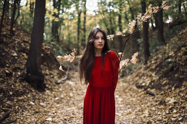 Caucasian woman standing on forest path