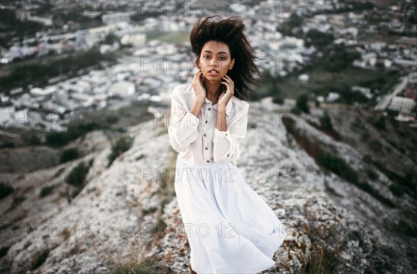 Caucasian woman standing on remote hilltop