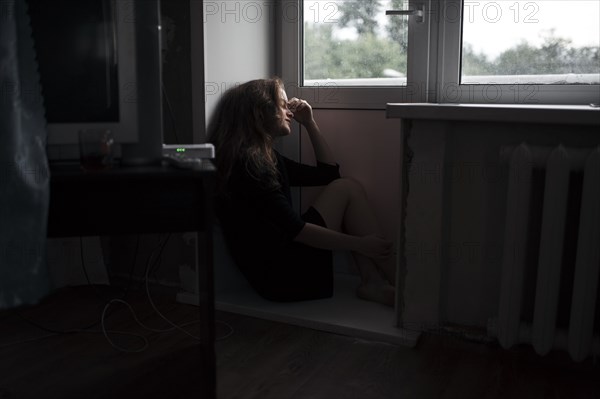 Caucasian woman sitting near door