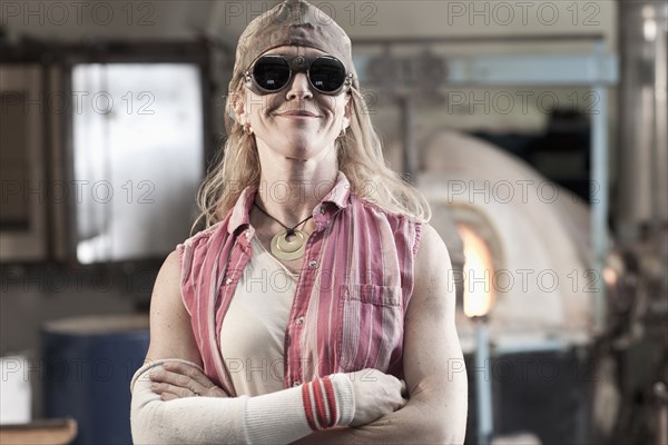 Caucasian woman in glass blowing studio