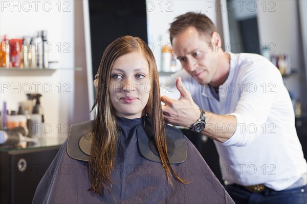 Woman having haircut in salon