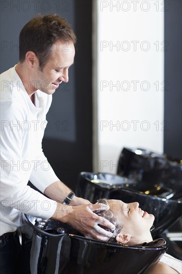 Woman having hair washed in salon