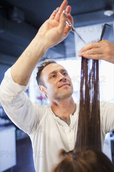 Hairdresser cutting hair in salon