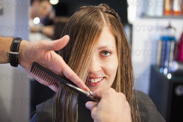 Woman having haircut in salon