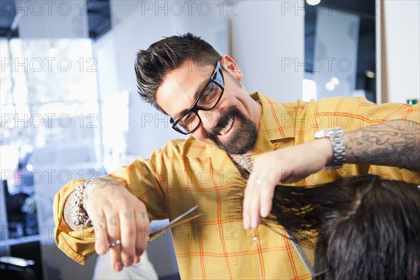 Hairdresser cutting hair in salon