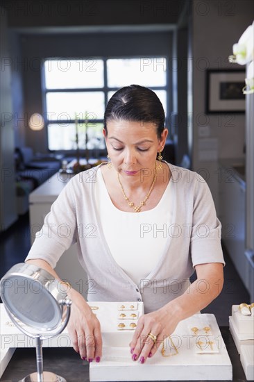 Hispanic woman working in jewelry store