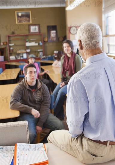 Teacher and students talking in classroom