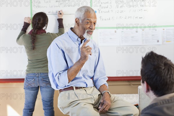 Teacher and students talking in classroom