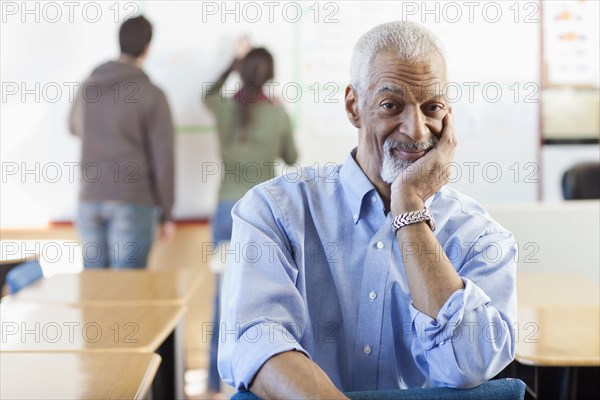 Black teacher sitting in classroom