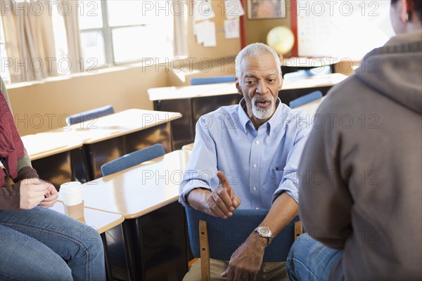 Teacher and students talking in classroom