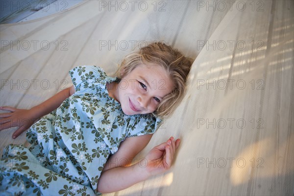 Caucasian girl laying in hammock