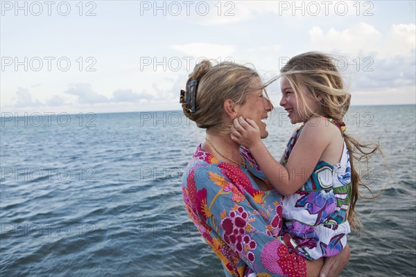 Caucasian mother and daughter enjoying the beach