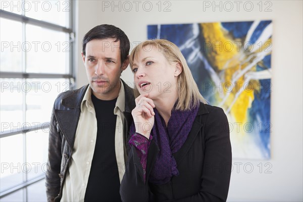 Couple looking at art in art gallery