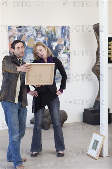 Couple looking at painting in art gallery